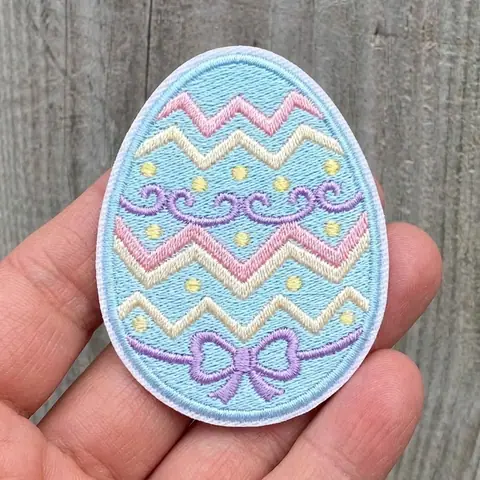 Pastel Easter egg patch held in a hand