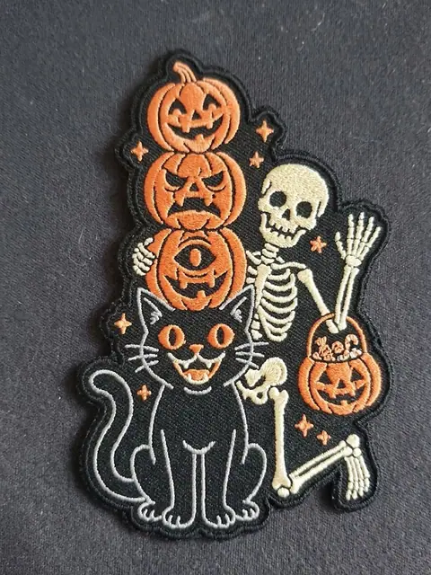 Embroidered Halloween patch with pumpkins, a skeleton and black cat